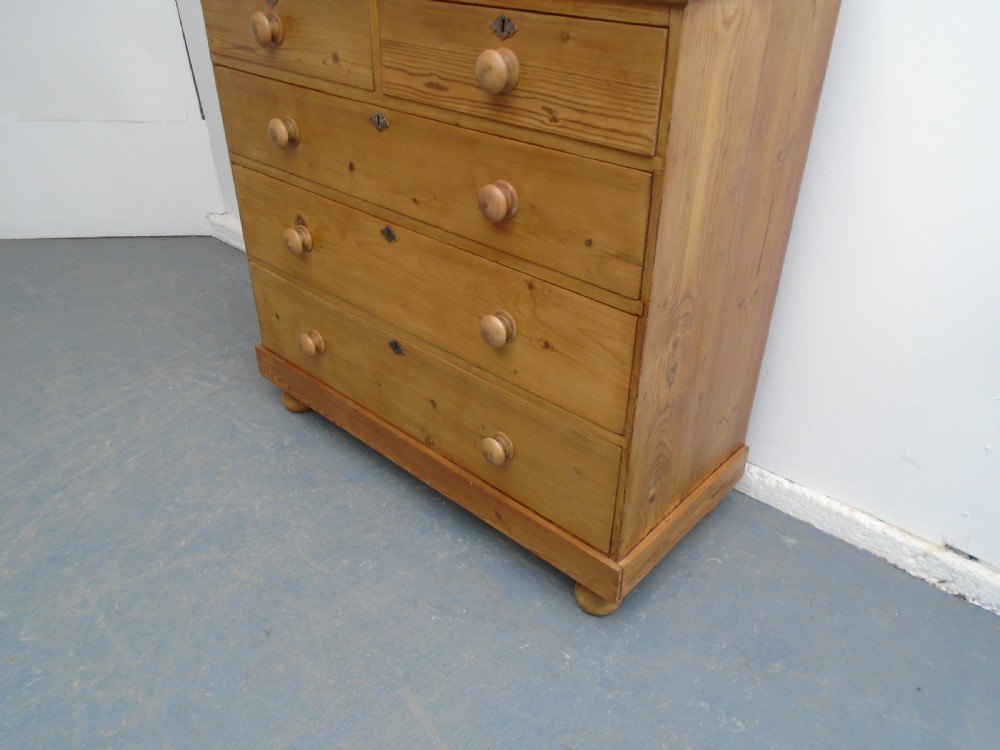 A Victorian waxed pine chest featuring two short over three long graduating drawers with turned wooden knobs. View III