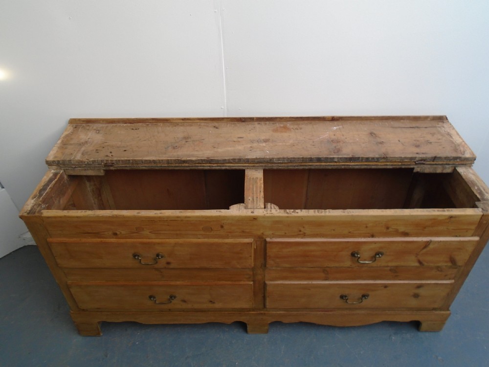 An extra wide Georgian waxed pine blanket box featuring a hinged top lid, brass swan-neck handles, faux drawer fronts, and a bracket base. View IX