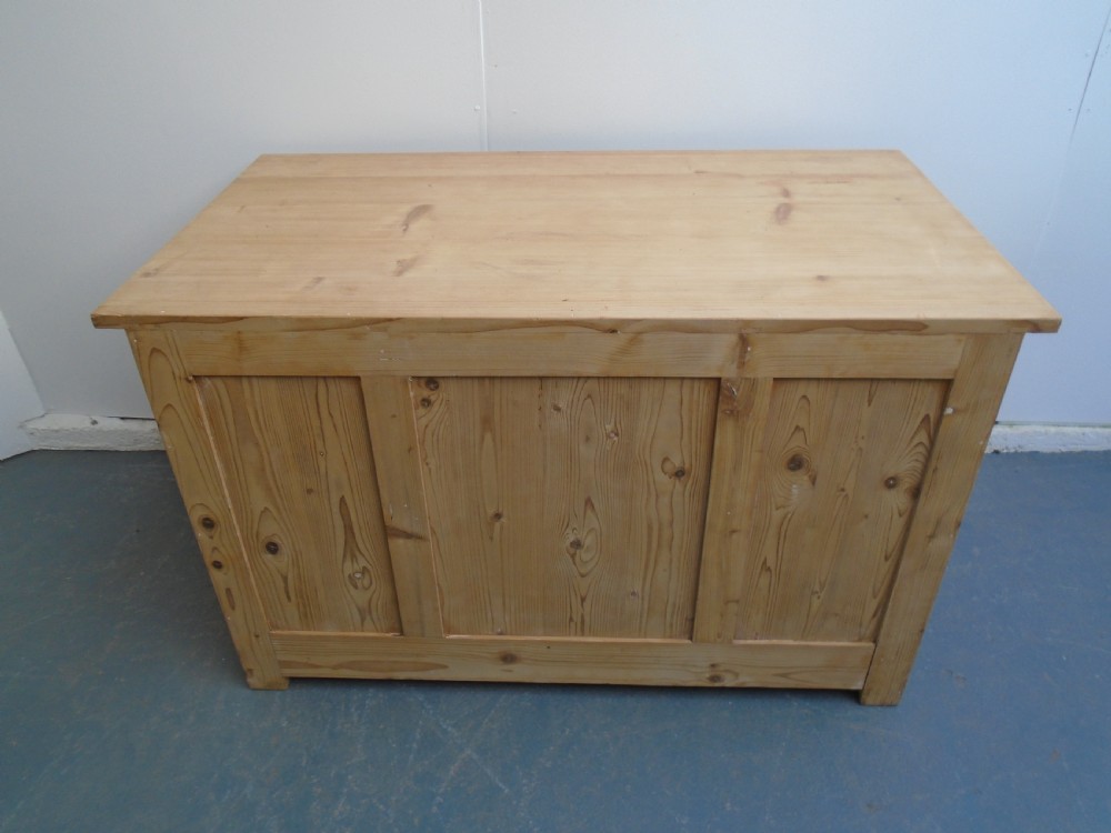 A large Victorian stripped pine pedestal desk featuring three top drawers, two panelled cupboard doors, and metal drop pull handles. View XI