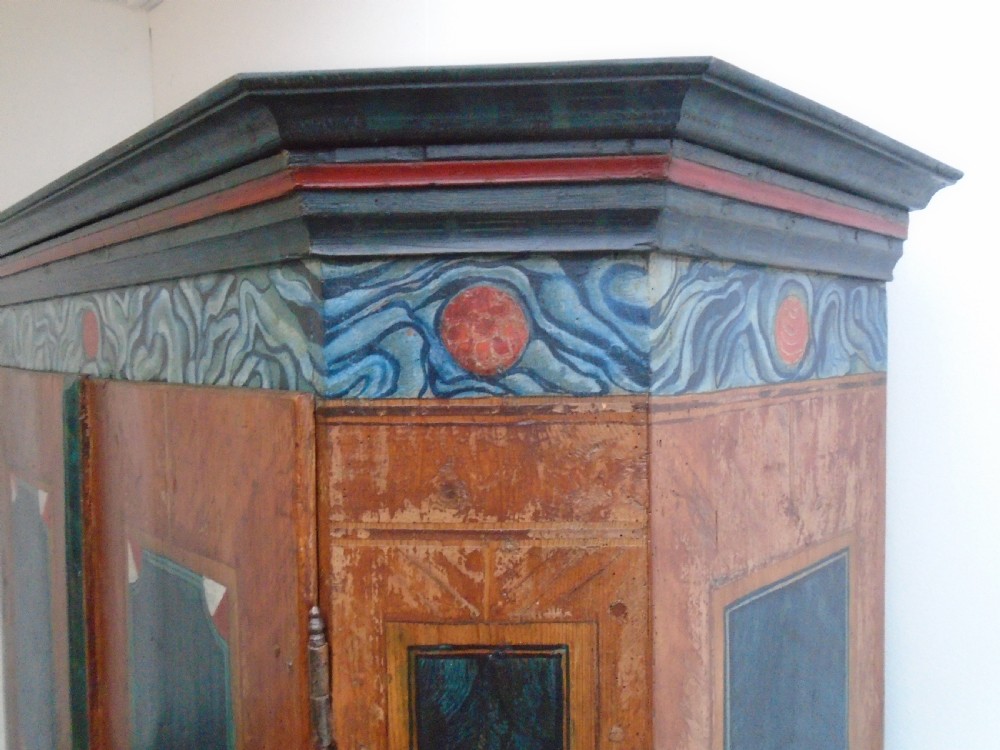 An antique Swedish painted pine two-door wardrobe featuring folk art geometric panels in teal green, red, and faux-grain wood finish. View V