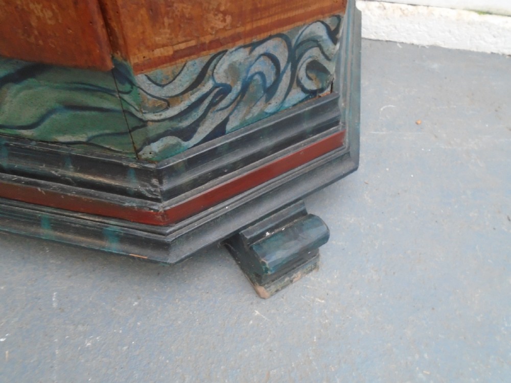 An antique Swedish painted pine two-door wardrobe featuring folk art geometric panels in teal green, red, and faux-grain wood finish. View X