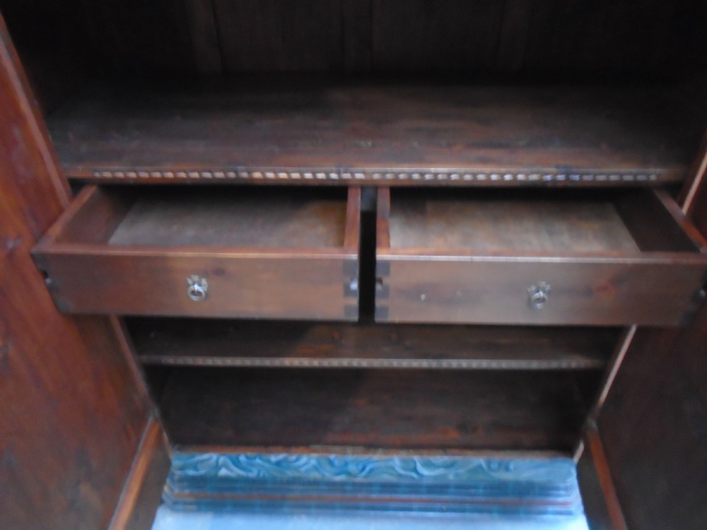 An antique Swedish painted pine two-door wardrobe featuring folk art geometric panels in teal green, red, and faux-grain wood finish. View XIII