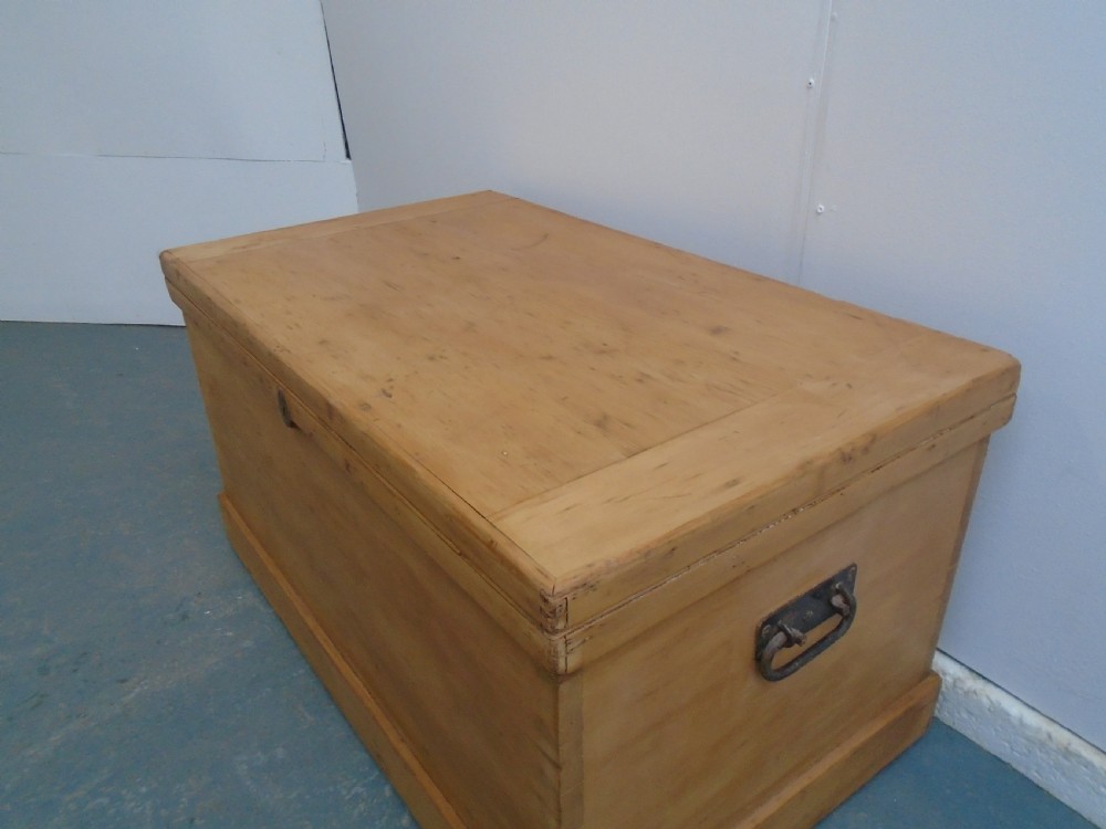 A rectangular Victorian waxed pine blanket box with side iron handles and a plinth base. View II