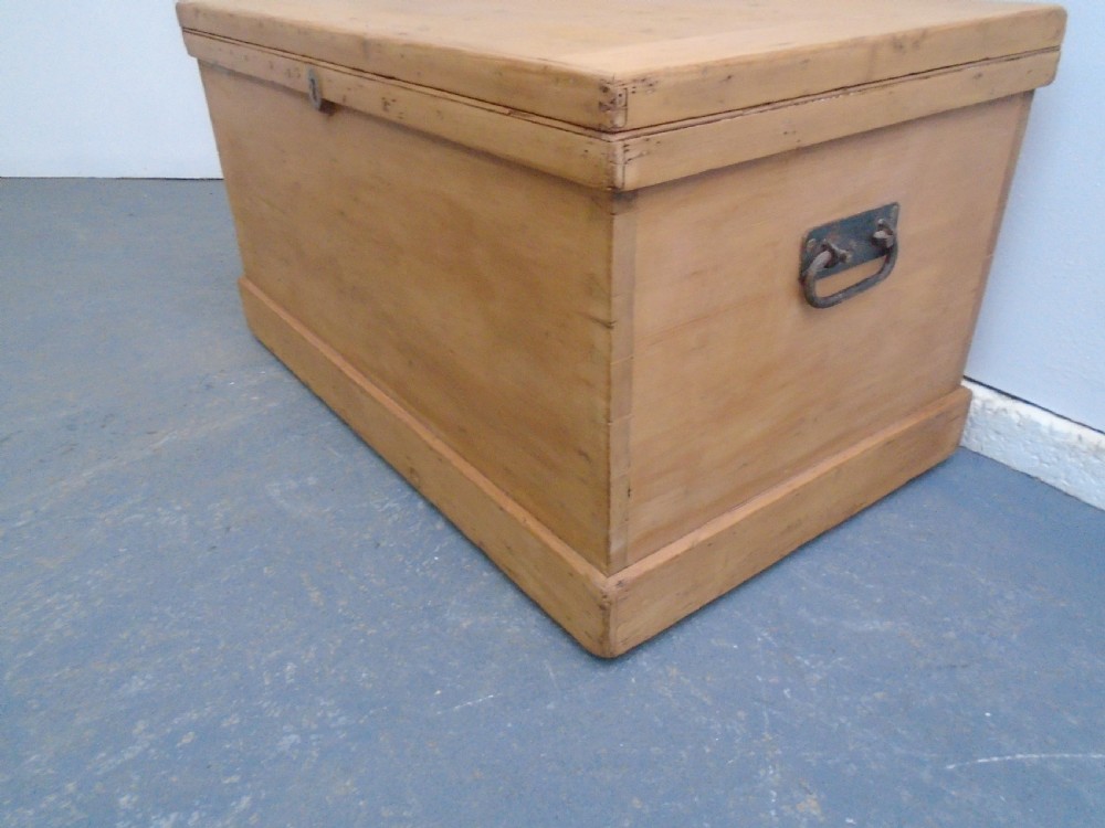 A rectangular Victorian waxed pine blanket box with side iron handles and a plinth base. View V