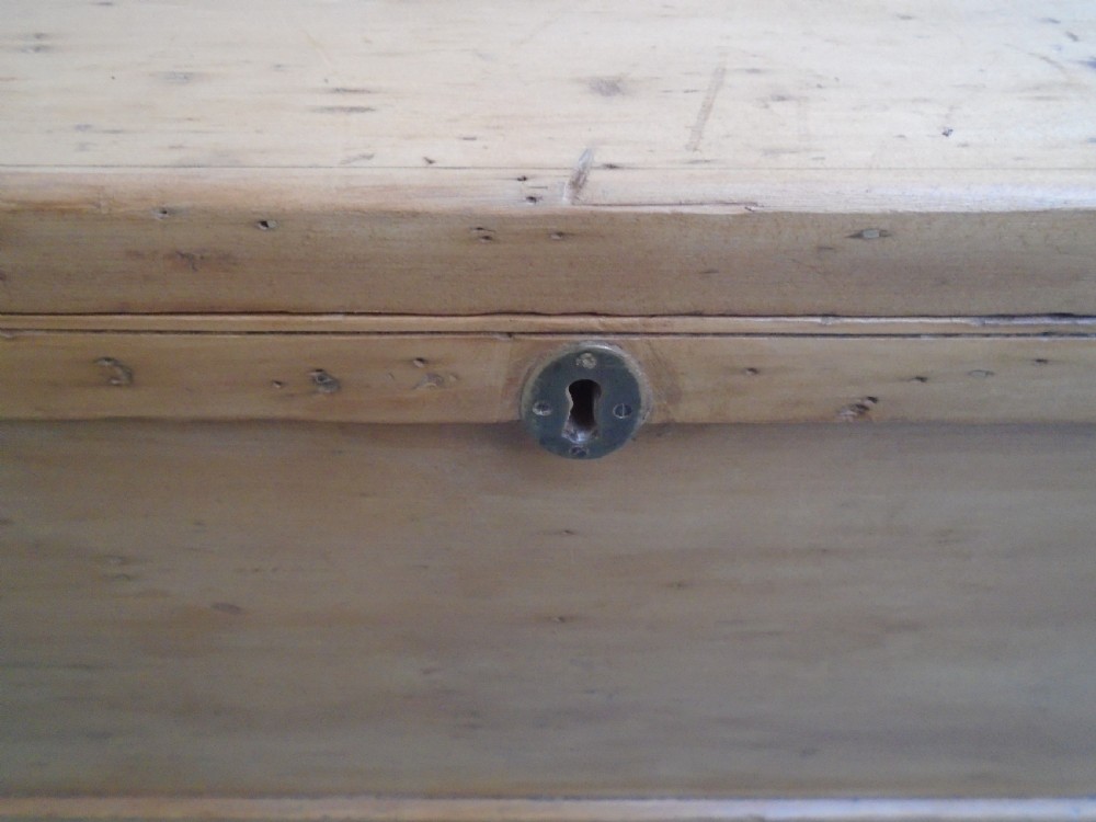 A rectangular Victorian waxed pine blanket box with side iron handles and a plinth base. View VIII