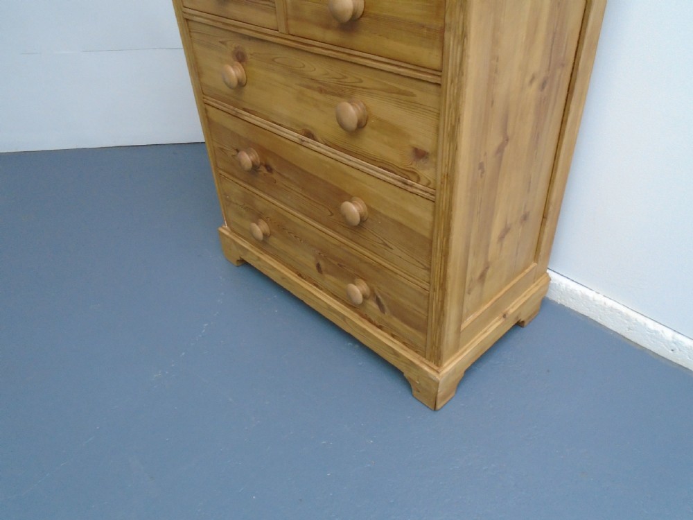 A waxed Victorian pine chest of drawers featuring a two-short-over-three-long drawer layout, panelled sides, and turned wooden knobs. View III