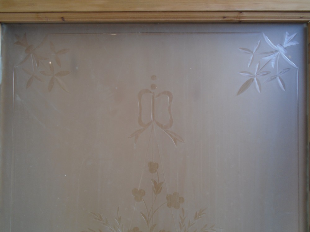 A stripped pine Victorian internal door featuring a large upper etched glass panel depicting an urn motif and a single timber panel below. View IV