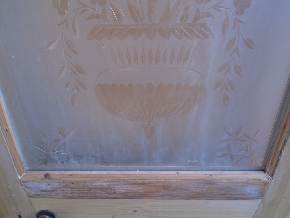 A stripped pine Victorian internal door featuring a large upper etched glass panel depicting an urn motif and a single timber panel below. View VII