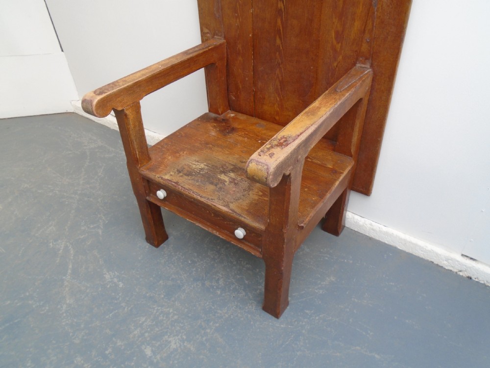 A Georgian pine chair-table featuring an armchair base with an under-seat drawer and an upright hinged timber backrest. View III
