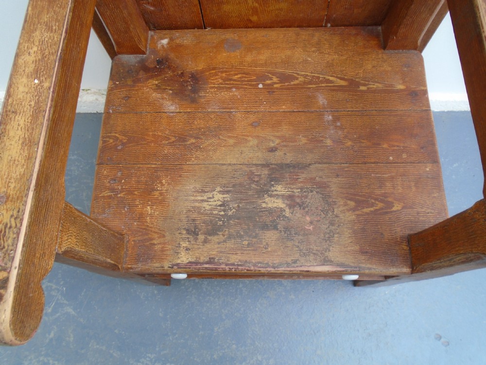 A Georgian pine chair-table featuring an armchair base with an under-seat drawer and an upright hinged timber backrest. View VI