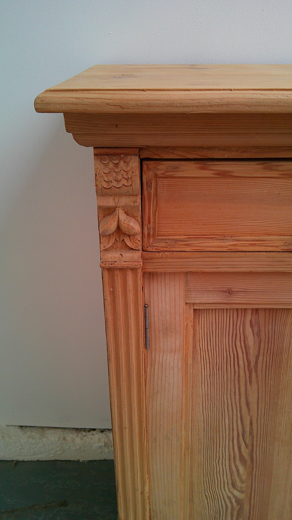 An early Victorian stripped pine shallow dresser base featuring two top drawers over a two-door panelled cupboard with turned bun feet. View IX