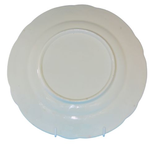 fig 1. A white soft-paste porcelain plate featuring hand-painted floral motifs, a gilded scalloped rim, and a small bird accent.