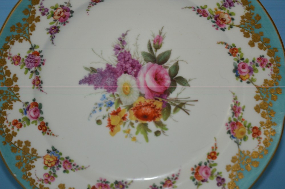 A circular Regency porcelain cabinet plate featuring a turquoise border with gilded foliage and a central hand-painted floral bouquet on a white ground. View II