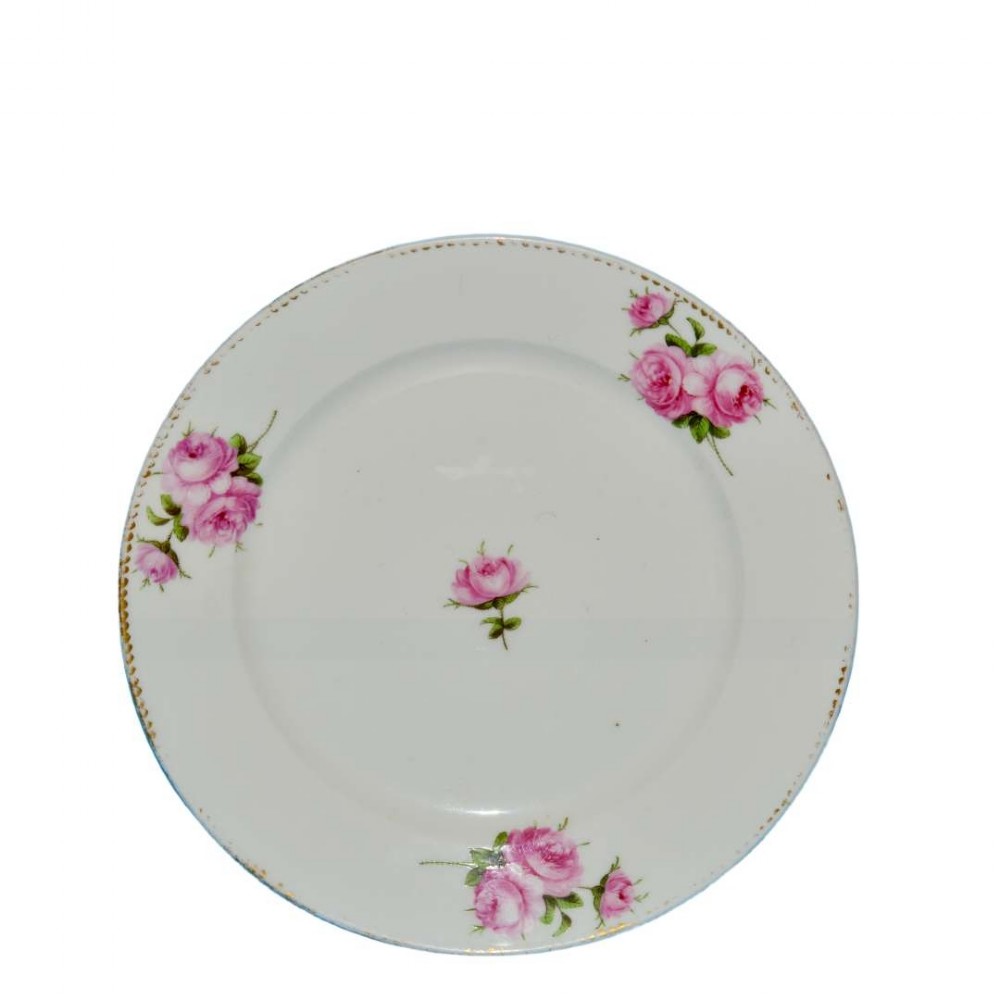 A circular white porcelain dessert plate decorated with hand-painted pink roses and a gilded rim.