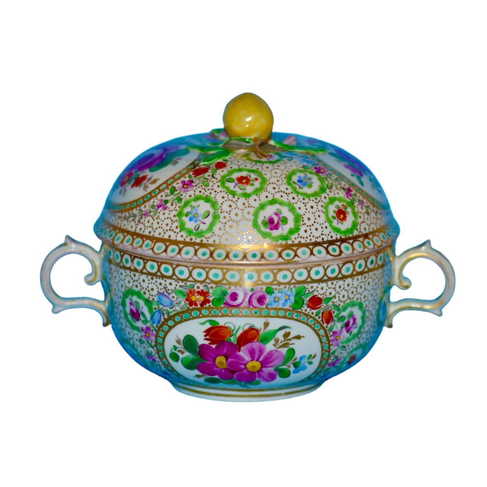 A 19th-century Meissen porcelain covered bowl decorated with hand-painted floral panels, intricate gold dot patterning, twin handles, and a yellow lemon finial on the lid.