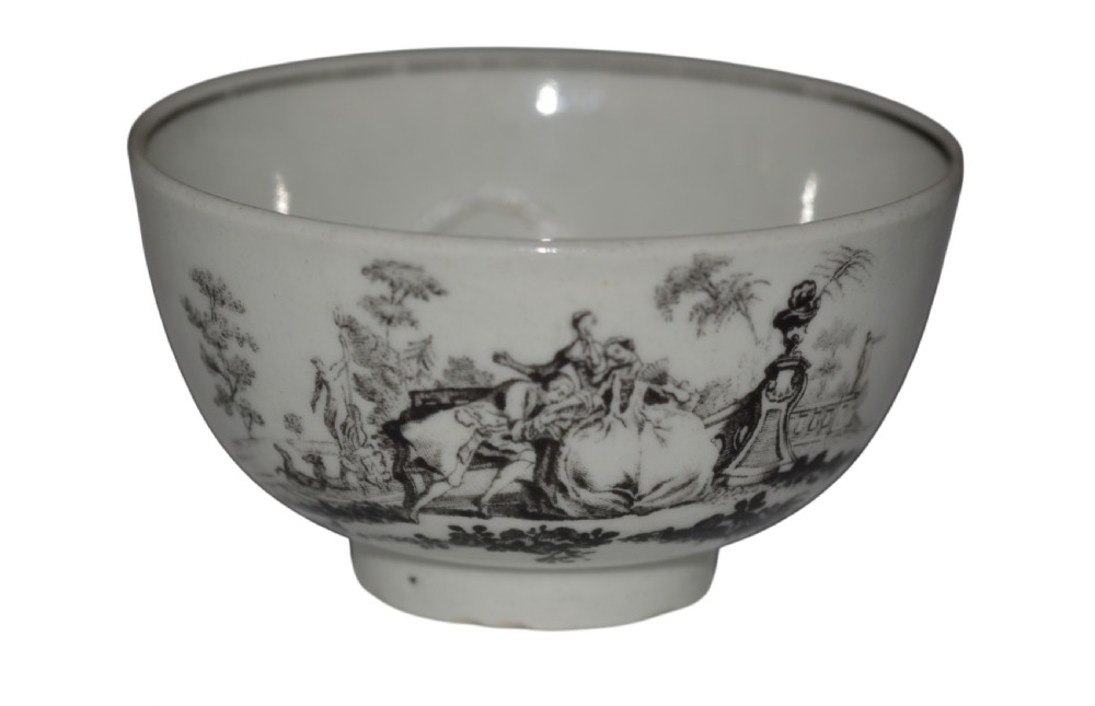 An eighteenth-century off-white soft-paste porcelain tea bowl featuring a black monochrome transfer-printed garden scene around its exterior. View II