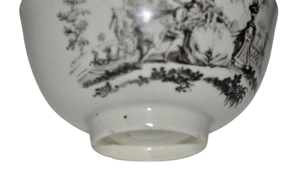 An eighteenth-century off-white soft-paste porcelain tea bowl featuring a black monochrome transfer-printed garden scene around its exterior. View III
