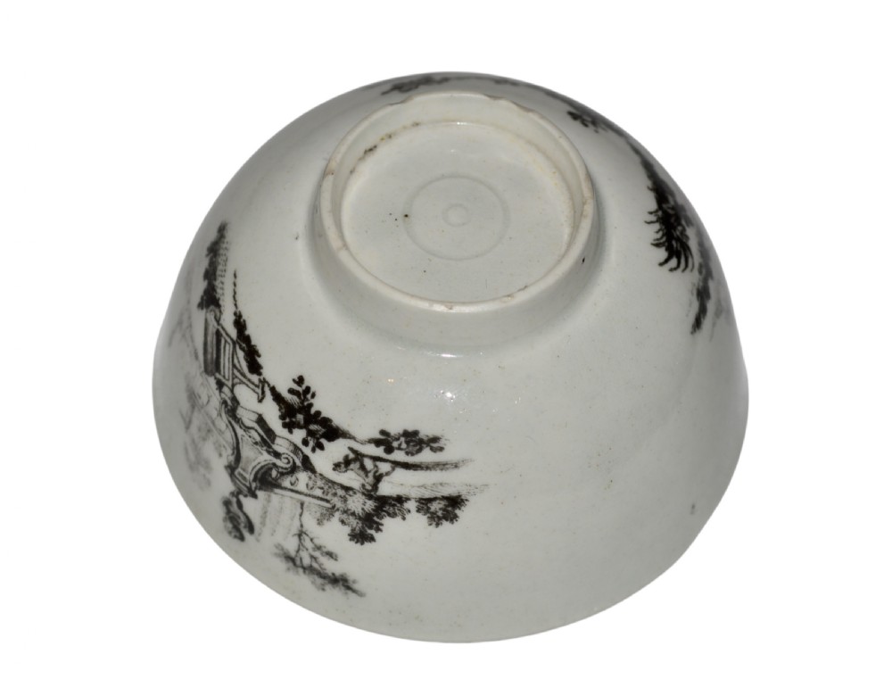 An eighteenth-century off-white soft-paste porcelain tea bowl featuring a black monochrome transfer-printed garden scene around its exterior. View IV