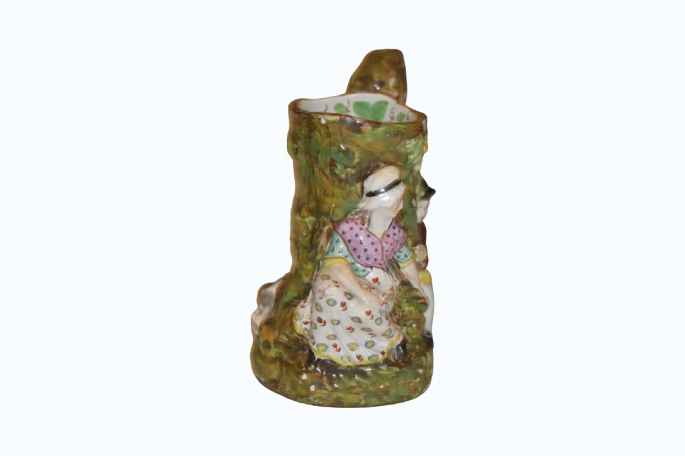An 18th-century Staffordshire pearlware Fair Hebe jug featuring relief-moulded figures around a tree trunk with a branch-shaped handle. View III