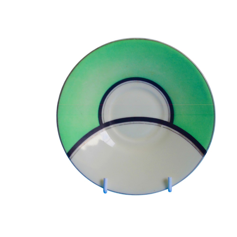 An Art Deco ceramic teacup, circular saucer, and square side plate featuring green and cream geometric panel decoration. View IV