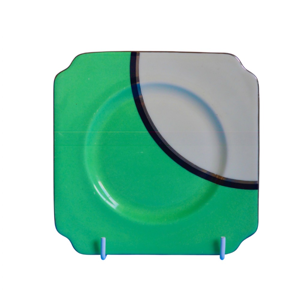 An Art Deco ceramic teacup, circular saucer, and square side plate featuring green and cream geometric panel decoration. View V