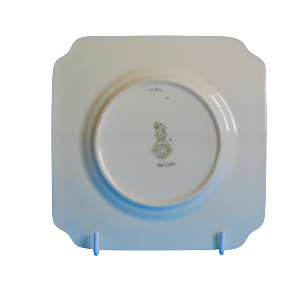 An Art Deco ceramic teacup, circular saucer, and square side plate featuring green and cream geometric panel decoration. View VIII