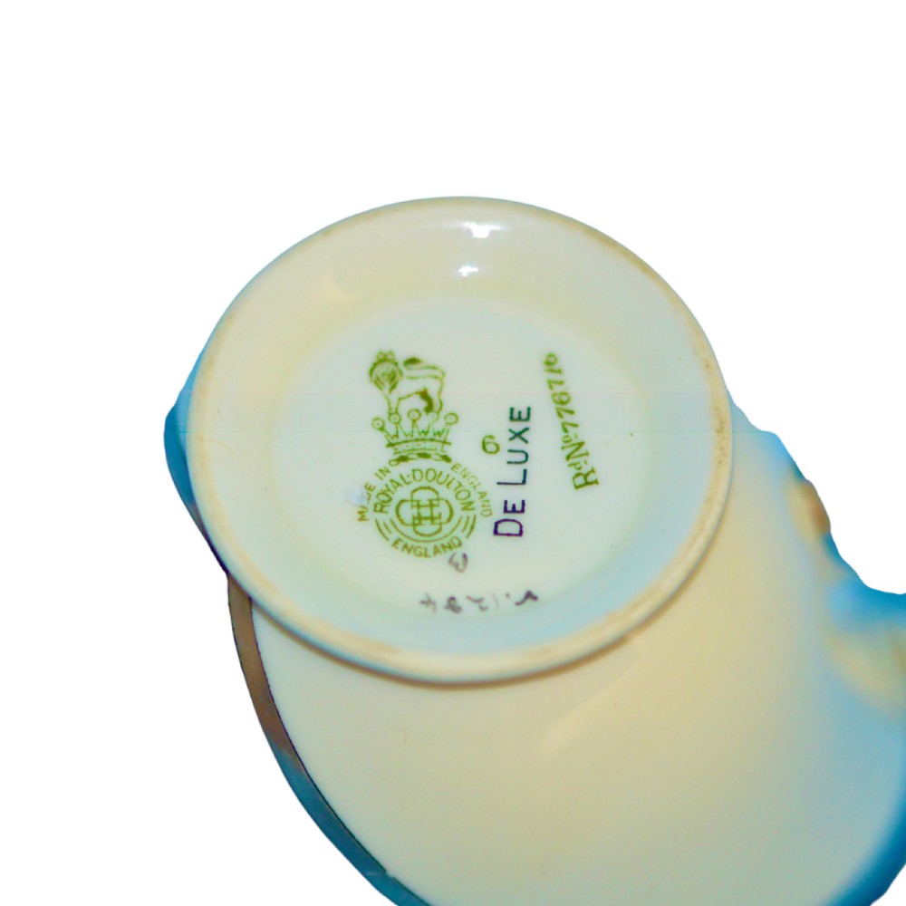 An Art Deco ceramic teacup, circular saucer, and square side plate featuring green and cream geometric panel decoration. View IX