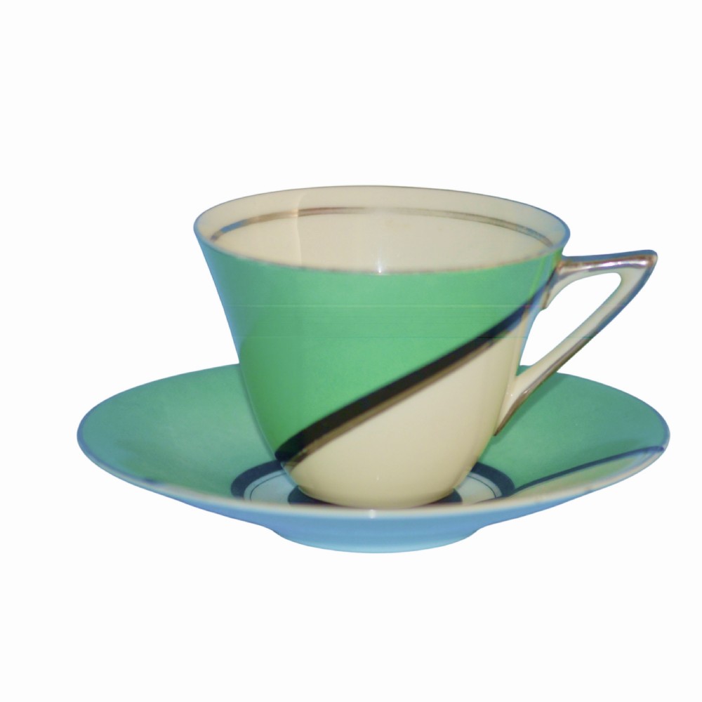 An Art Deco ceramic teacup, circular saucer, and square side plate featuring green and cream geometric panel decoration. View X