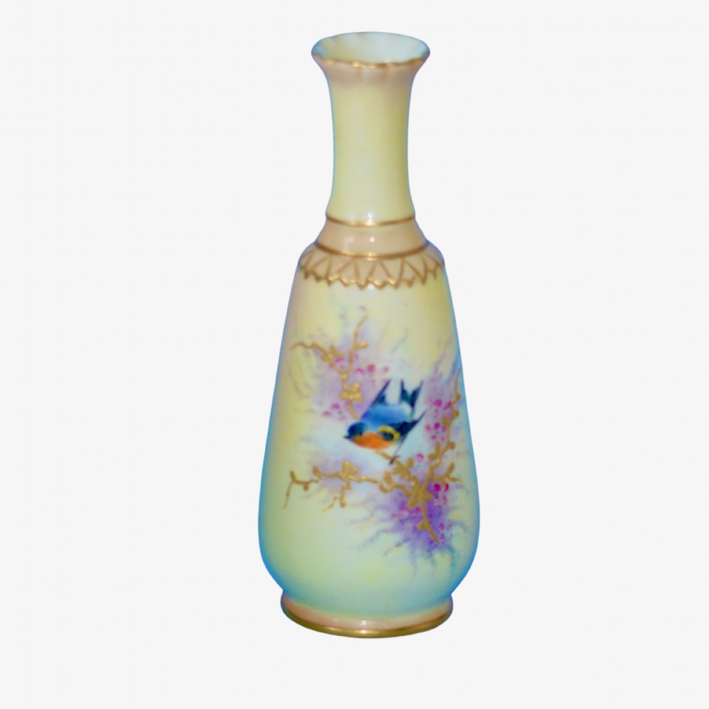 A pale yellow porcelain vase with a tapered body and flared neck, featuring a hand-painted blue bird on a branch with gilt accents.