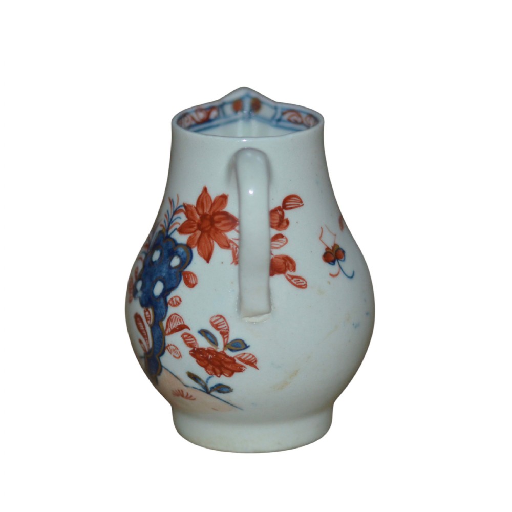 An 18th-century Lowestoft soft-paste porcelain sparrow-beak jug featuring hand-painted red and blue foliage and bird motifs. View IV