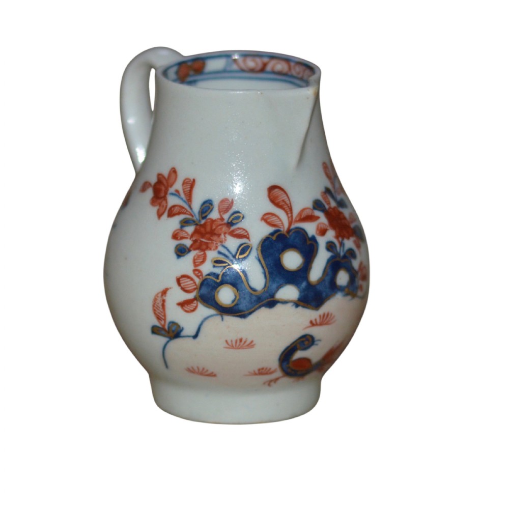 An 18th-century Lowestoft soft-paste porcelain sparrow-beak jug featuring hand-painted red and blue foliage and bird motifs. View V