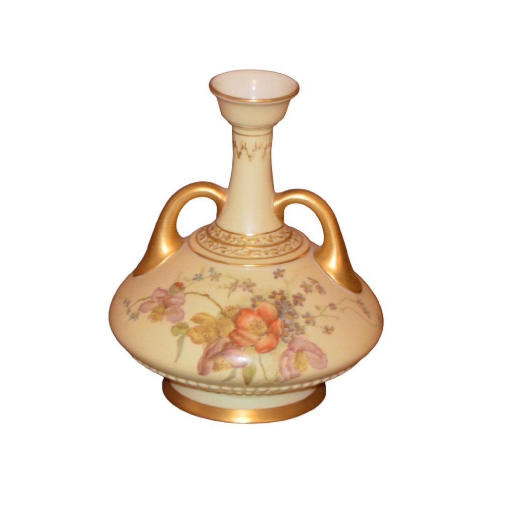 A late Victorian Royal Worcester blush ivory porcelain vase featuring twin gilded handles and hand-painted floral motifs on a flared neck and bulbous body.