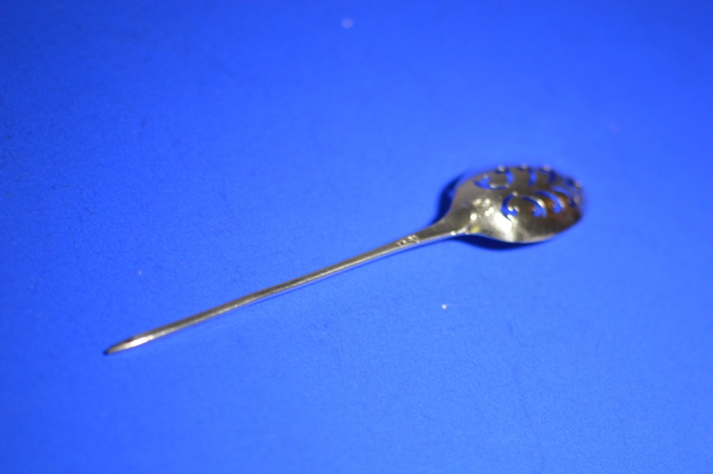 An 18th-century silver mote spoon featuring a hand-pierced oval bowl and a long tapered stem ending in a sharp point. View II