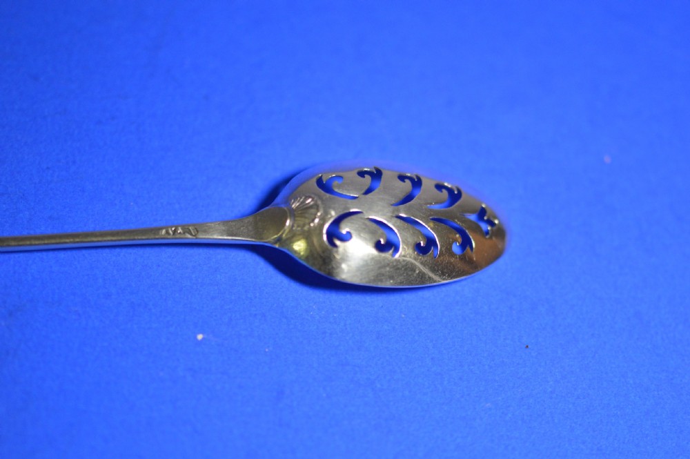An 18th-century silver mote spoon featuring a hand-pierced oval bowl and a long tapered stem ending in a sharp point. View III