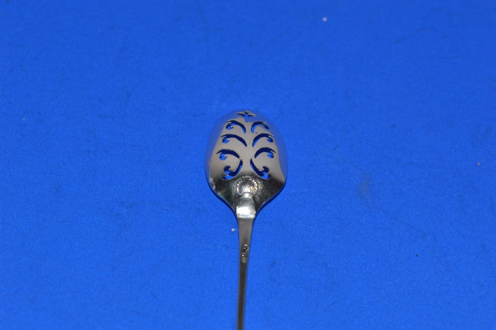 An 18th-century silver mote spoon featuring a hand-pierced oval bowl and a long tapered stem ending in a sharp point. View IV