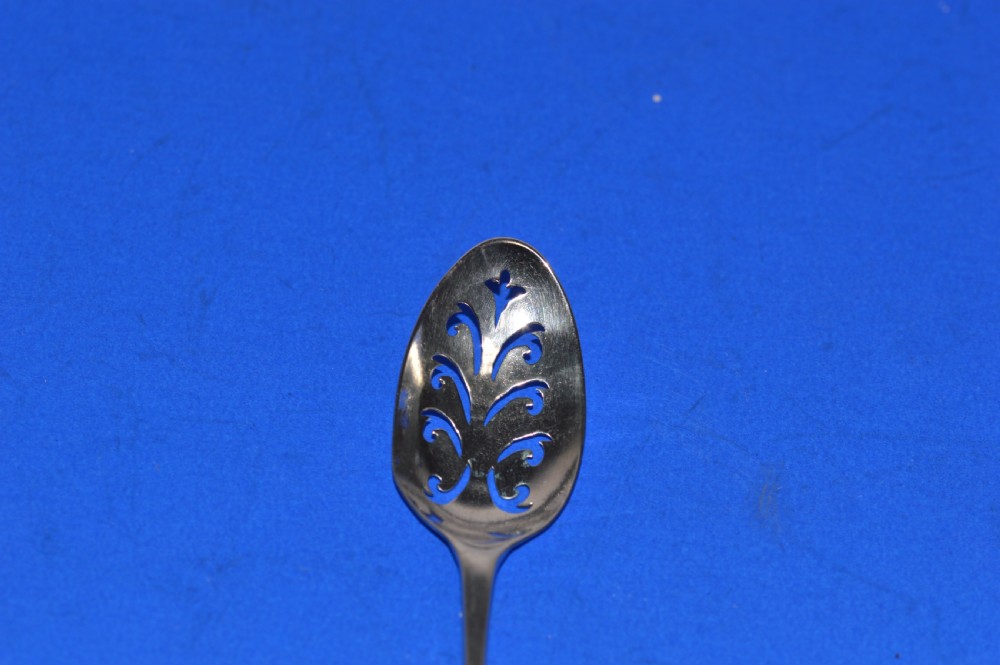 An 18th-century silver mote spoon featuring a hand-pierced oval bowl and a long tapered stem ending in a sharp point. View V