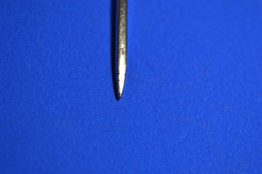 An 18th-century silver mote spoon featuring a hand-pierced oval bowl and a long tapered stem ending in a sharp point. View VI