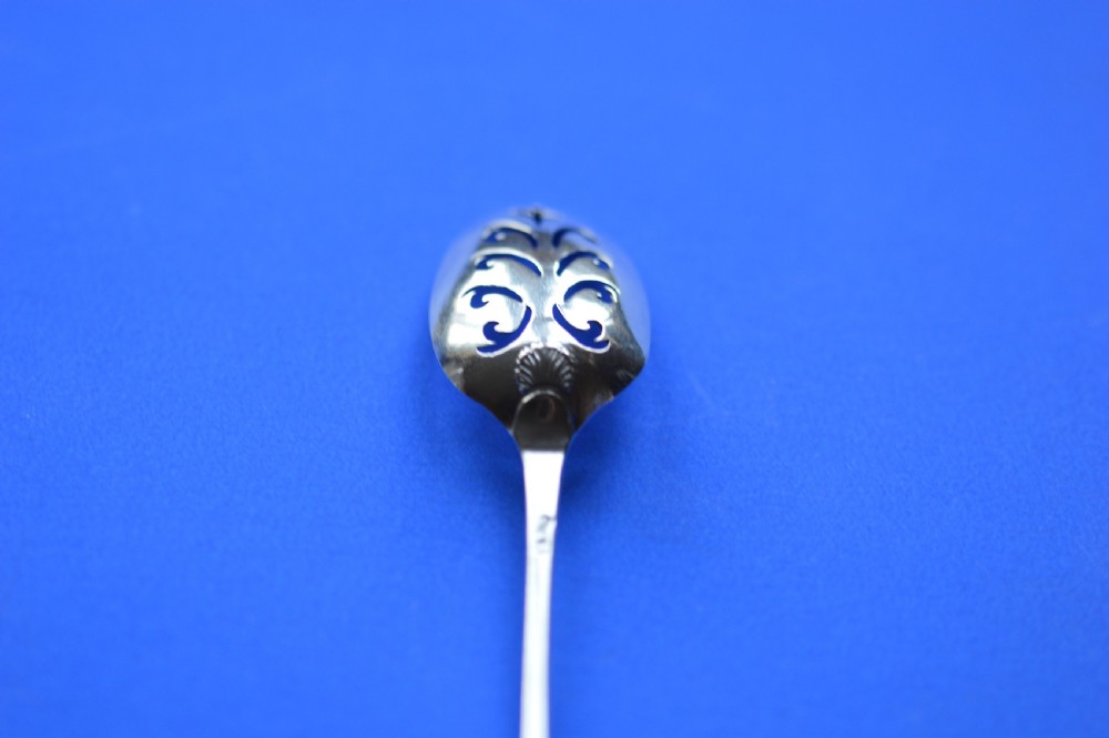 An 18th-century silver mote spoon featuring a hand-pierced oval bowl and a long tapered stem ending in a sharp point. View VII