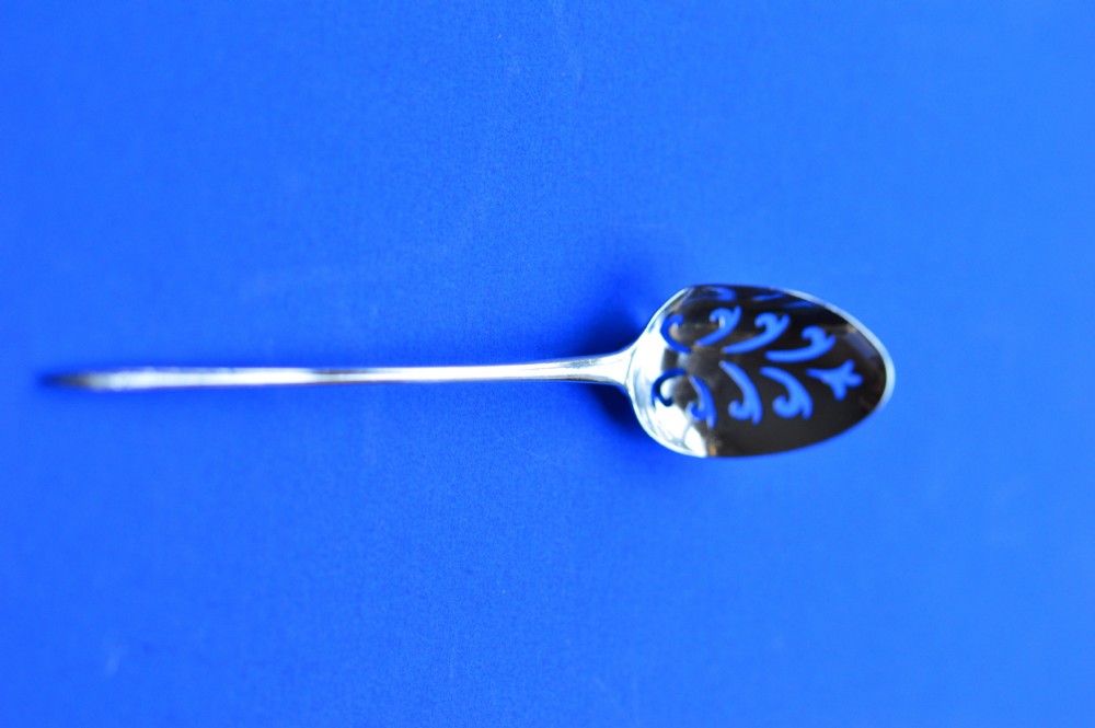 An 18th-century silver mote spoon featuring a hand-pierced oval bowl and a long tapered stem ending in a sharp point. View X