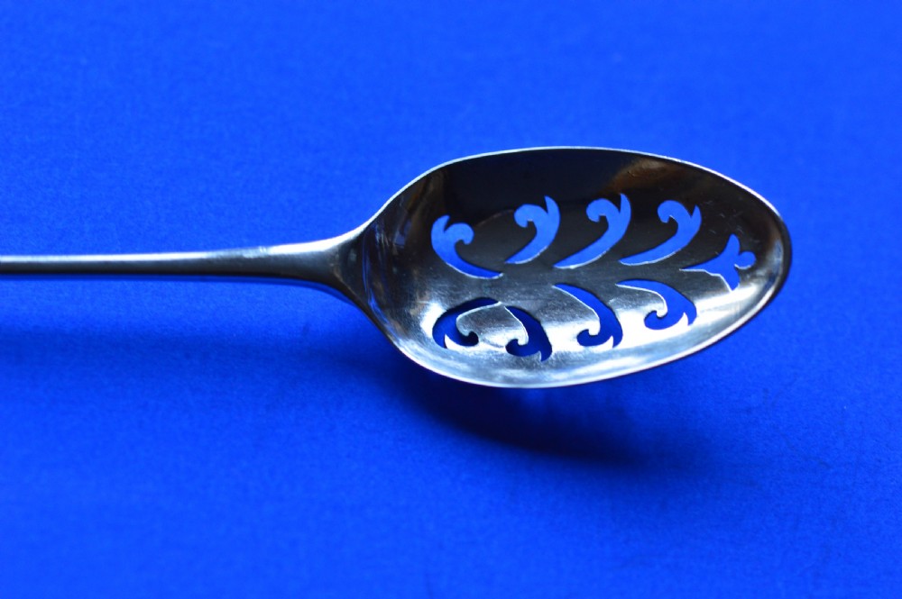 An 18th-century silver mote spoon featuring a hand-pierced oval bowl and a long tapered stem ending in a sharp point. View XI