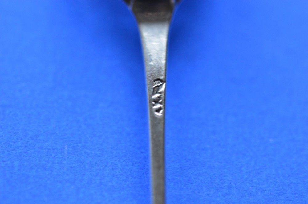 An 18th-century silver mote spoon featuring a hand-pierced oval bowl and a long tapered stem ending in a sharp point. View XIII