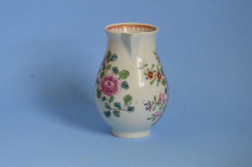 An 18th-century soft-paste porcelain sparrow beak cream jug with hand-painted pink and orange floral sprigs on a white ground. View III