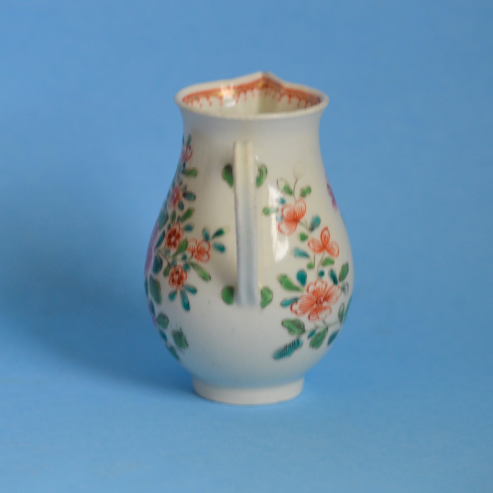 An 18th-century soft-paste porcelain sparrow beak cream jug with hand-painted pink and orange floral sprigs on a white ground. View IV