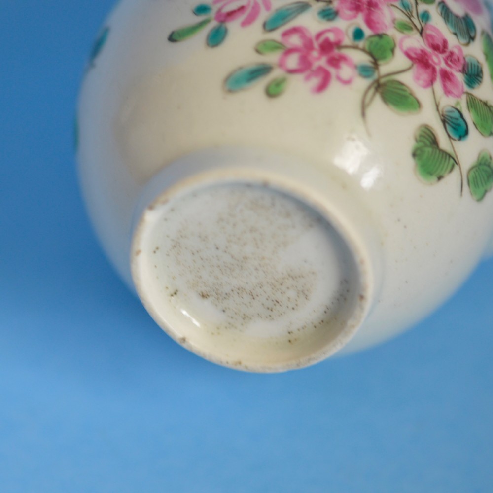 An 18th-century soft-paste porcelain sparrow beak cream jug with hand-painted pink and orange floral sprigs on a white ground. View VI