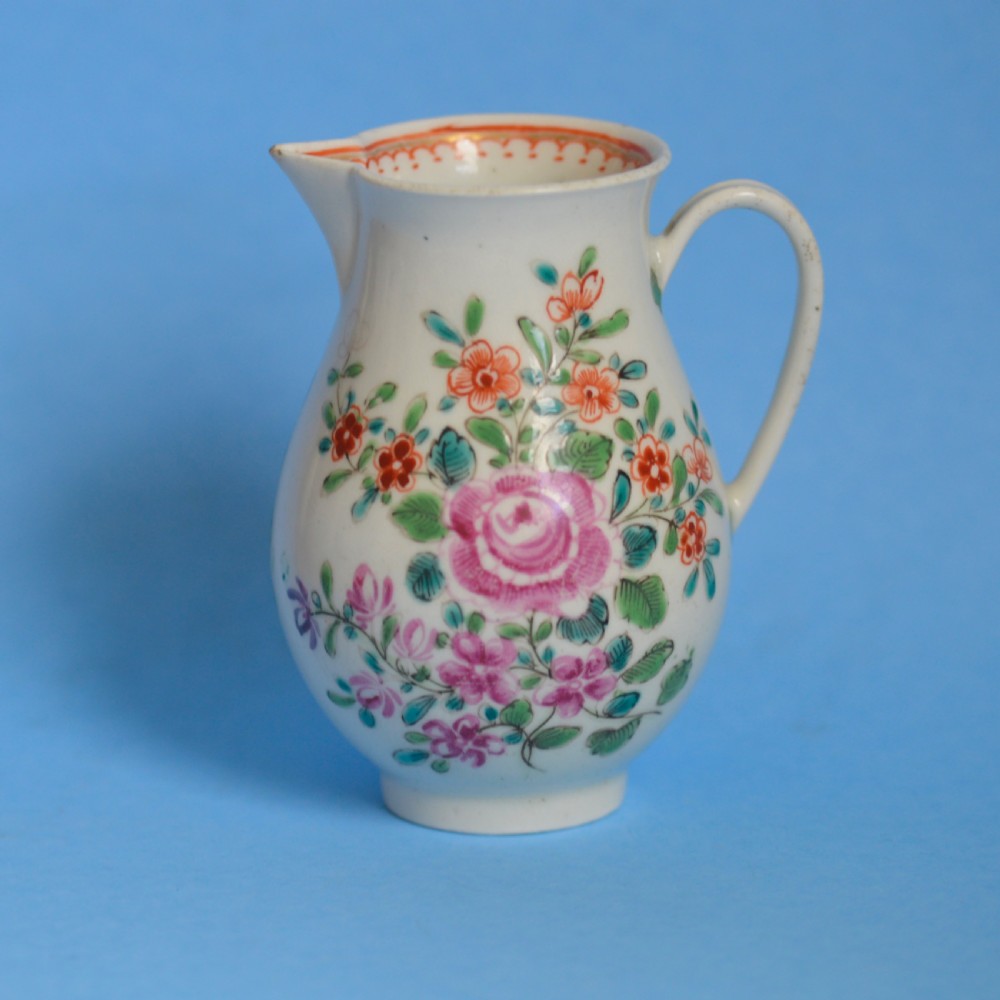 An 18th-century soft-paste porcelain sparrow beak cream jug with hand-painted pink and orange floral sprigs on a white ground. View VII