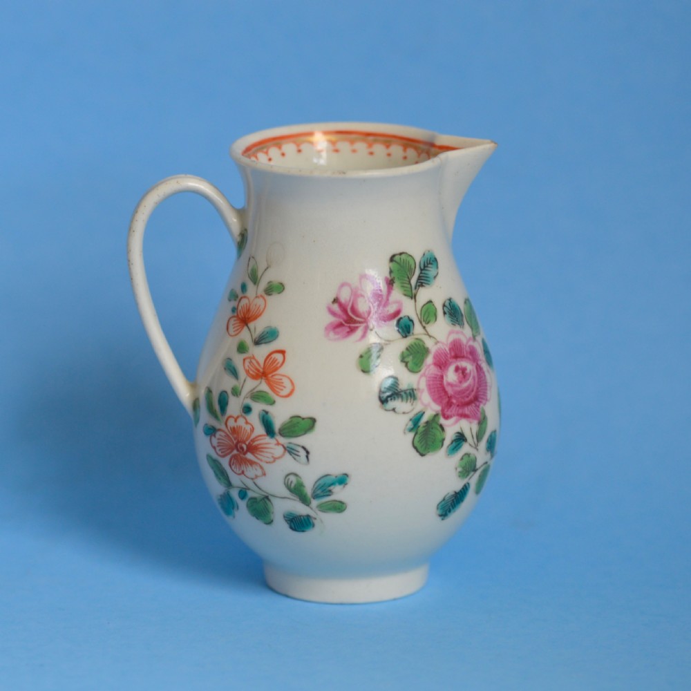 An 18th-century soft-paste porcelain sparrow beak cream jug with hand-painted pink and orange floral sprigs on a white ground. View VIII