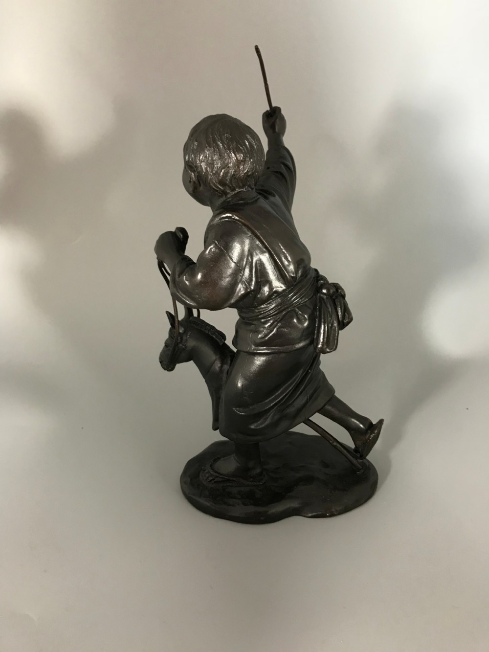 BRONZE OKIMONO OF BOY ON HOBBY HORSE  View III