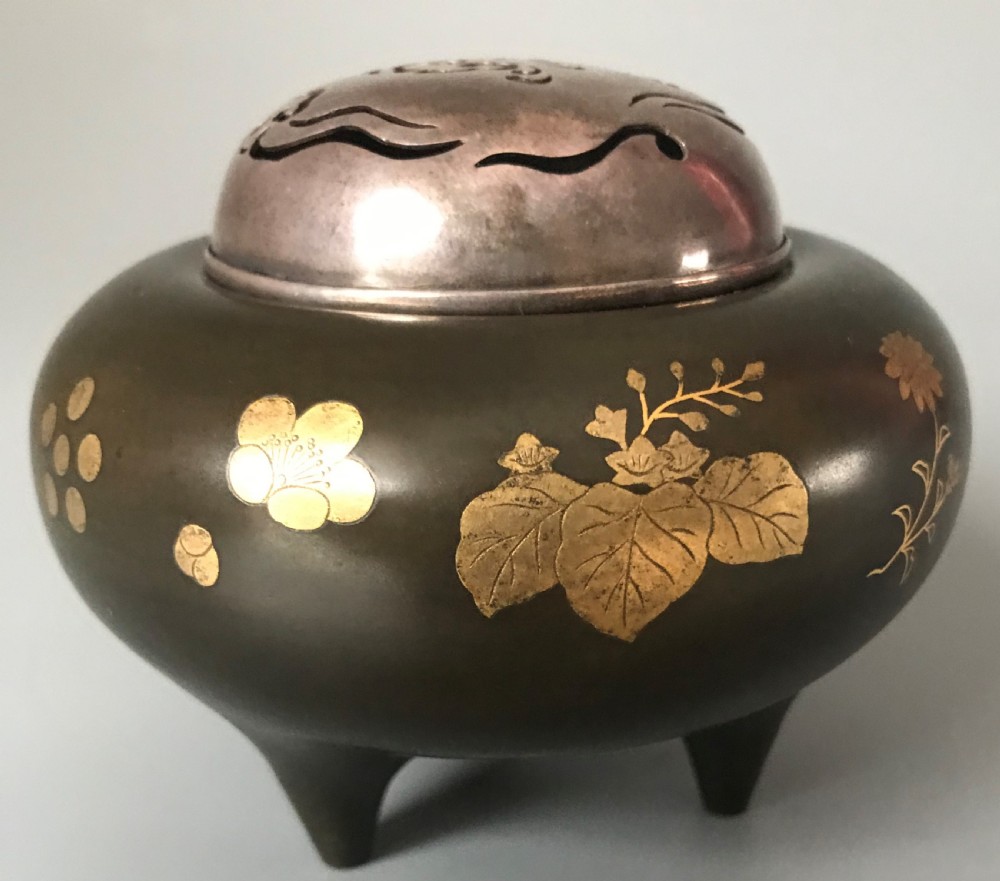 A tripod dark bronze incense burner featuring gold inlaid phoenix bird motifs and a pierced silver lid. View IV