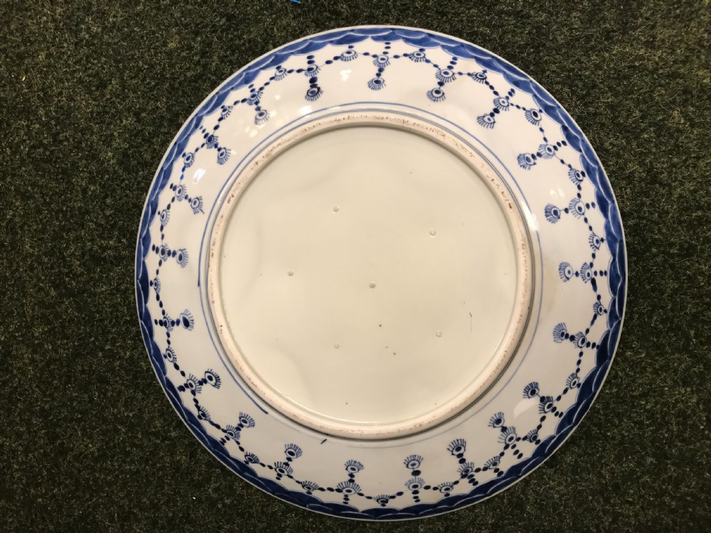 A large round Japanese Imari charger plate featuring intricate hand-painted blue, red, and gold patterns with floral and avian motifs. View II