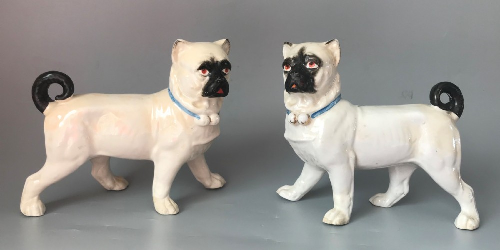 Pair Continental porcelain pug dogs .